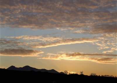 Sunset over mountain range with colorful clouds