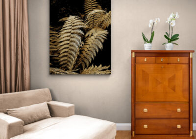 Fern artwork above a wooden cabinet in a nature-inspired interior design setting.