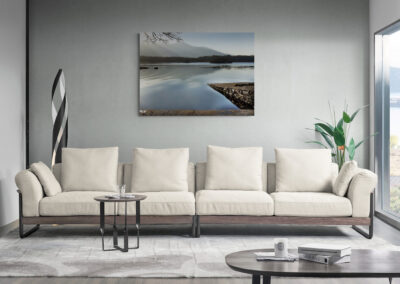 Modern living room with cream sofa, minimalist decor, and large window.