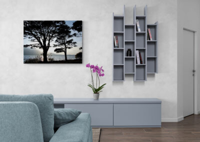 Modern living room with wall art, gray bookshelf, and console table. #moderninteriordesign #homedecor