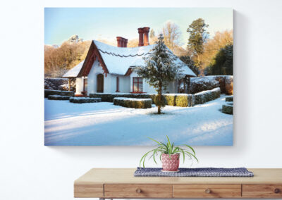 Snow-covered winter cottage with red accents, perfect for a cozy holiday home.