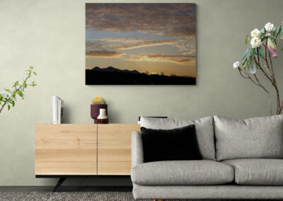 Sunset landscape painting over a modern gray sofa, home decor