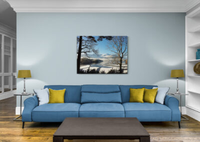 Winter landscape photograph by Pauline Christie featuring snow, mountains, and a lake.