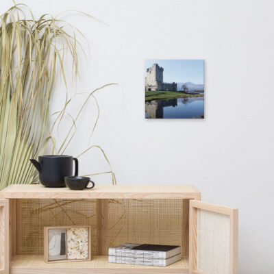 Ross Castle in Killarney, Ireland, reflected in the lake on a sunny day.