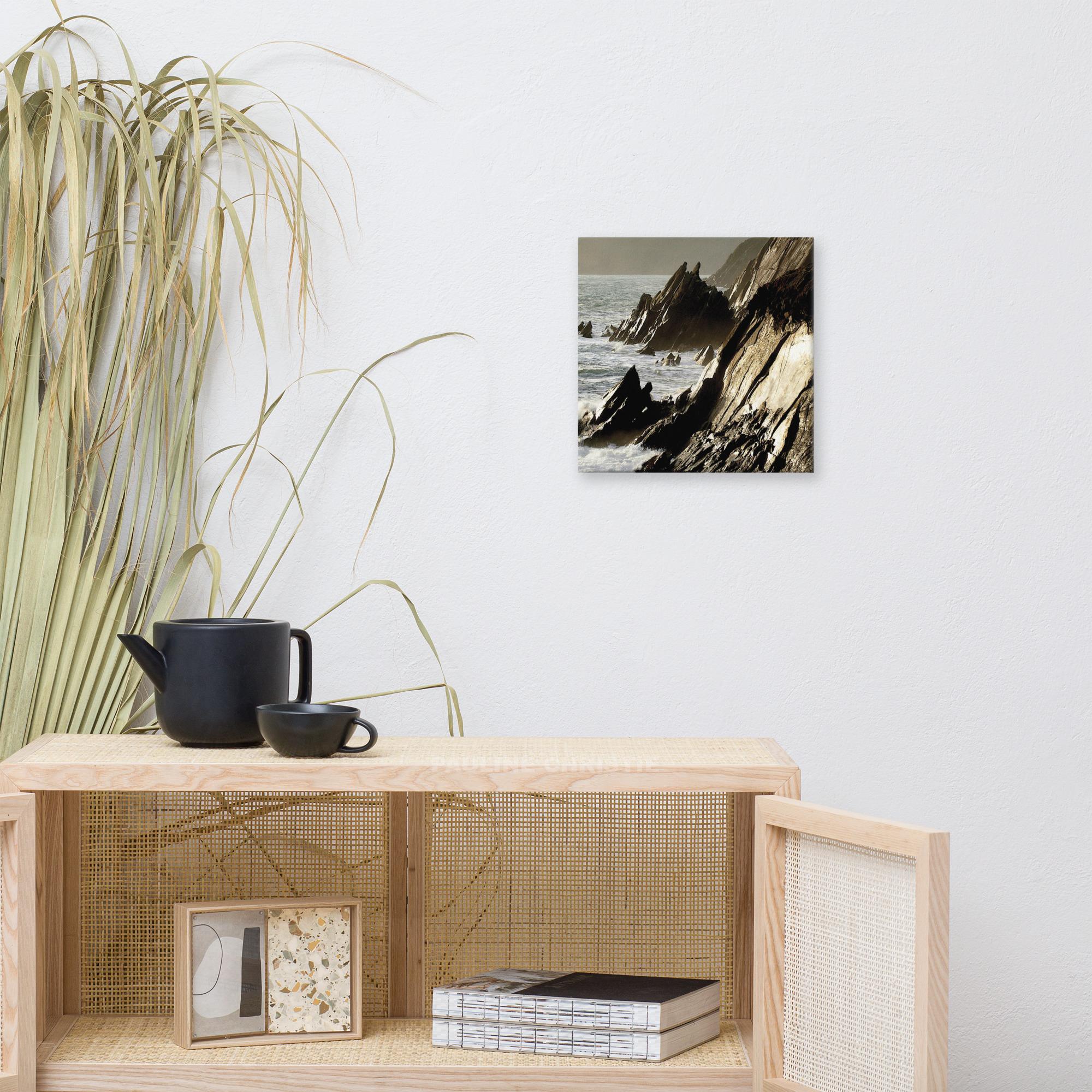 Coastal rocks at Couminole Kerry, with waves crashing against the rugged shoreline.