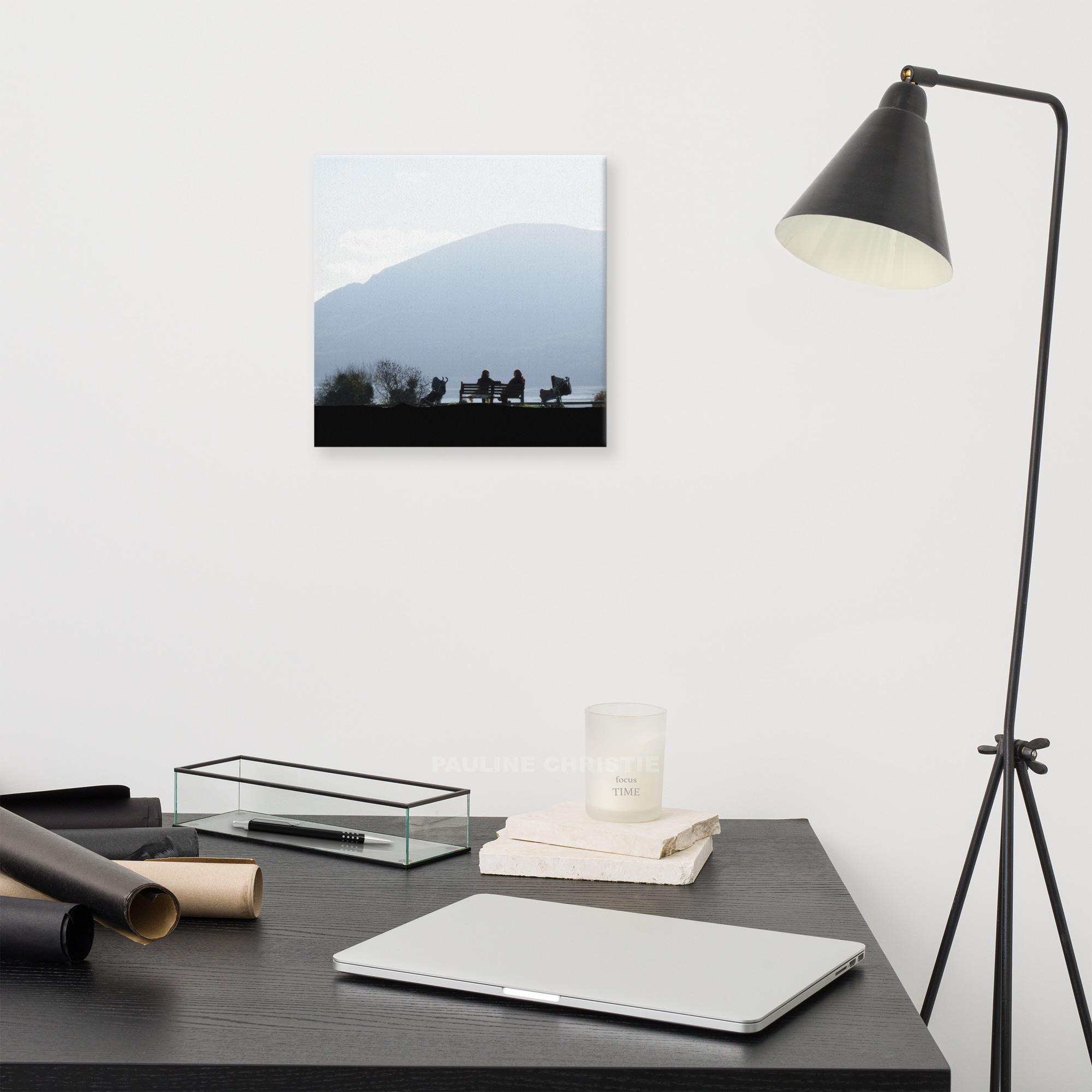 Silhouetted women chatting on a bench overlooking Killarney lakes, Ireland.