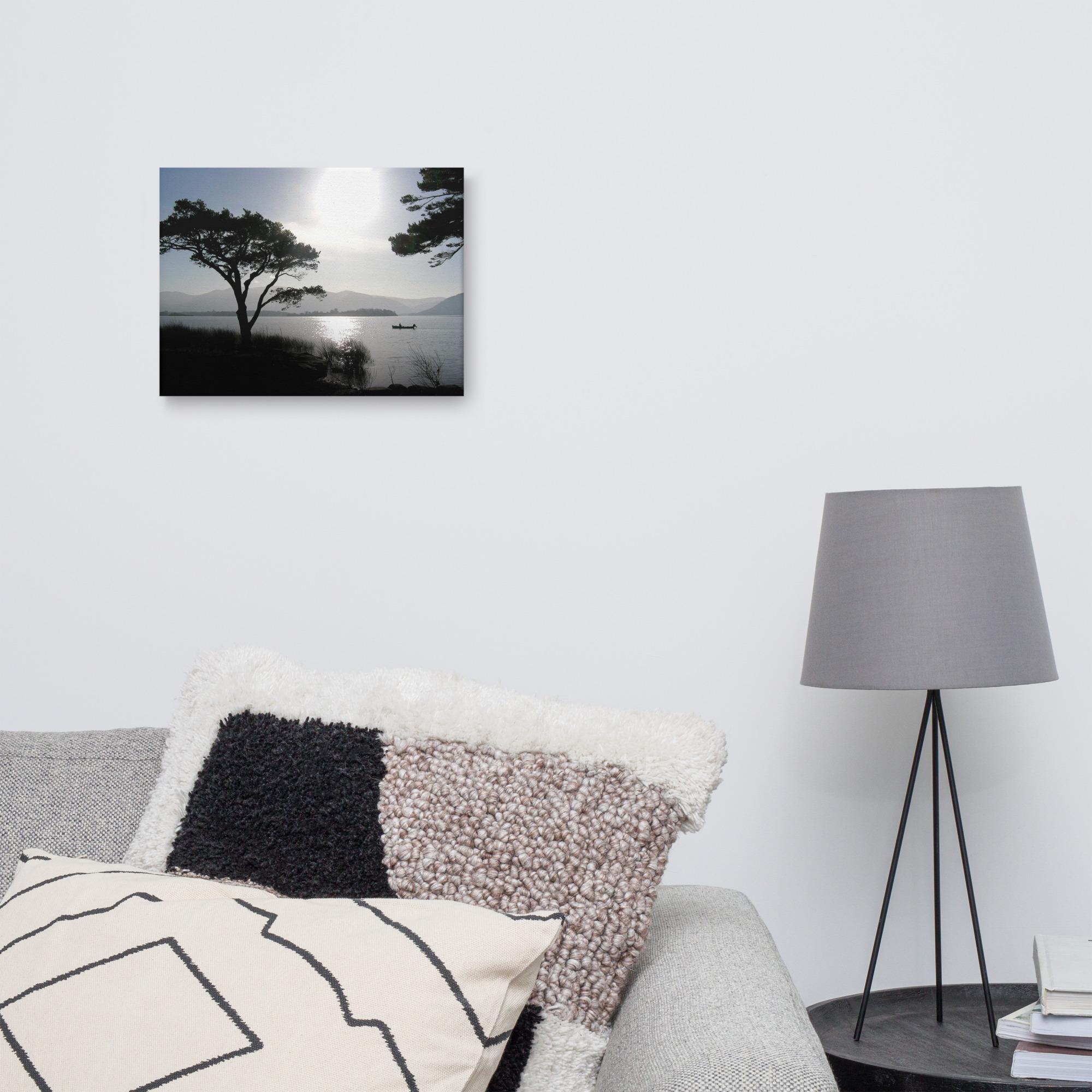 Silhouette of a fisherman out on the lakes of Killarney at sunset