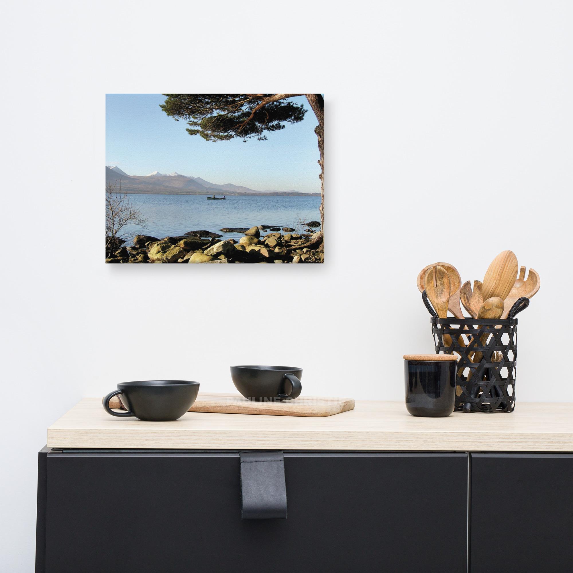 Landscape photo of Killarney Lakes with a lone fisherman in a boat