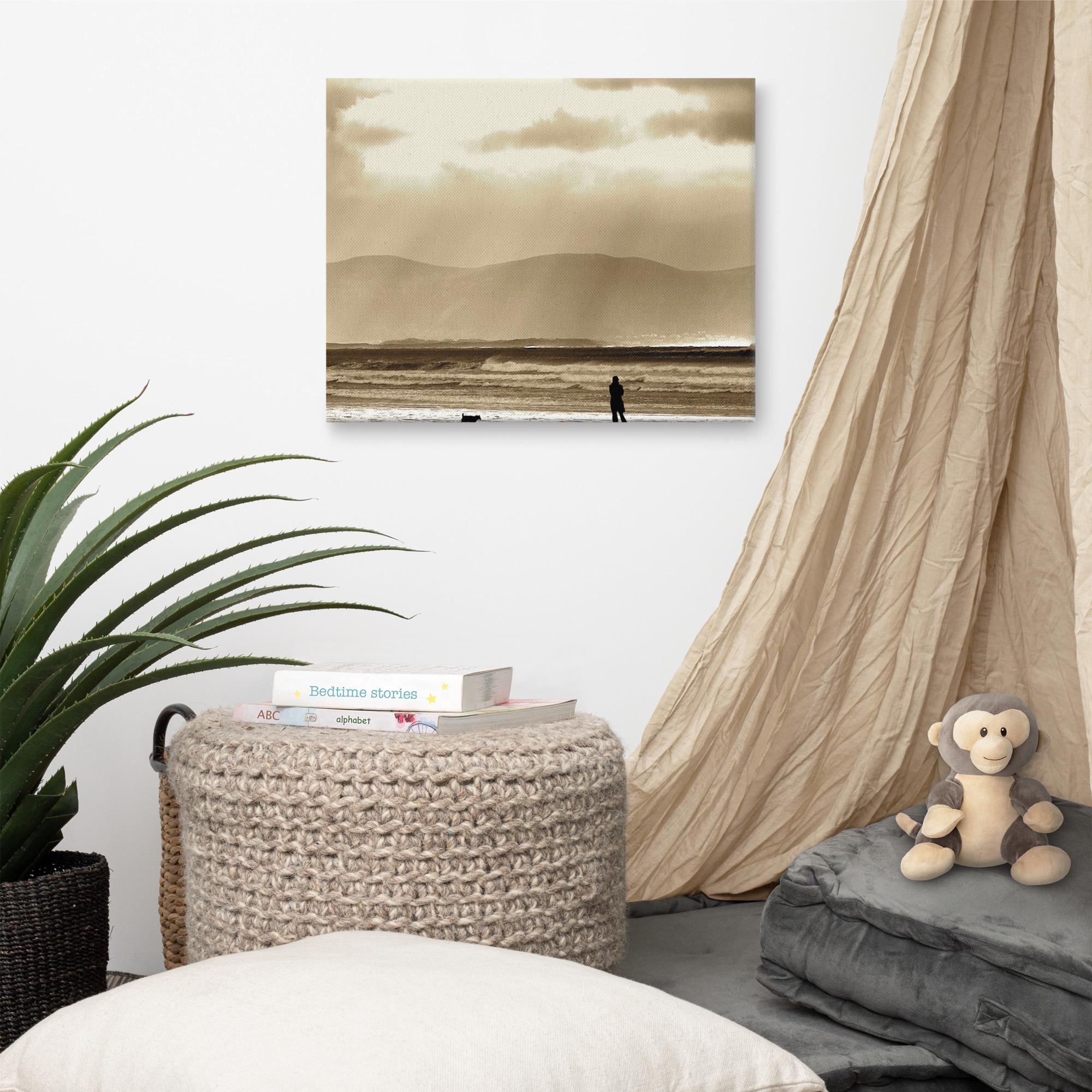 Mesmerising image of person walking dog on Inch Strand beach on a wintry day.