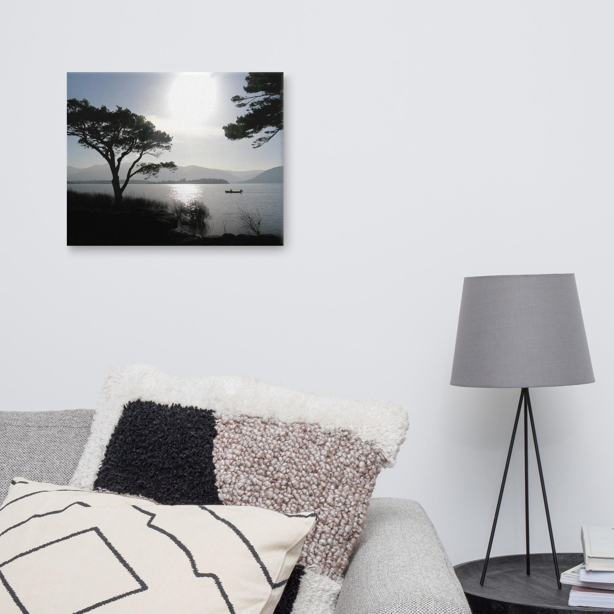 Silhouette of a fisherman out on the lakes of Killarney at sunset
