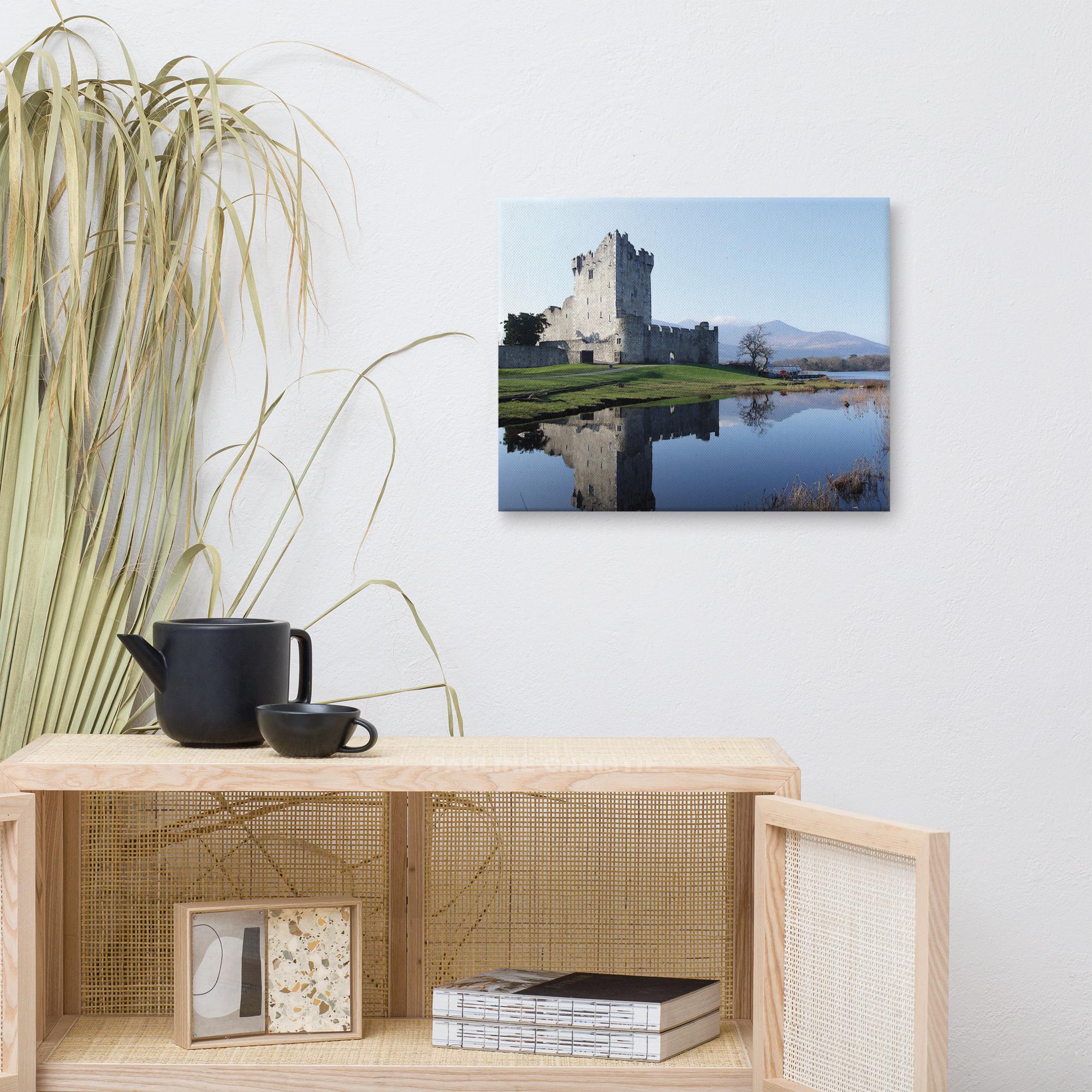 Ross Castle in Killarney, Ireland, reflected in the lake on a sunny day.