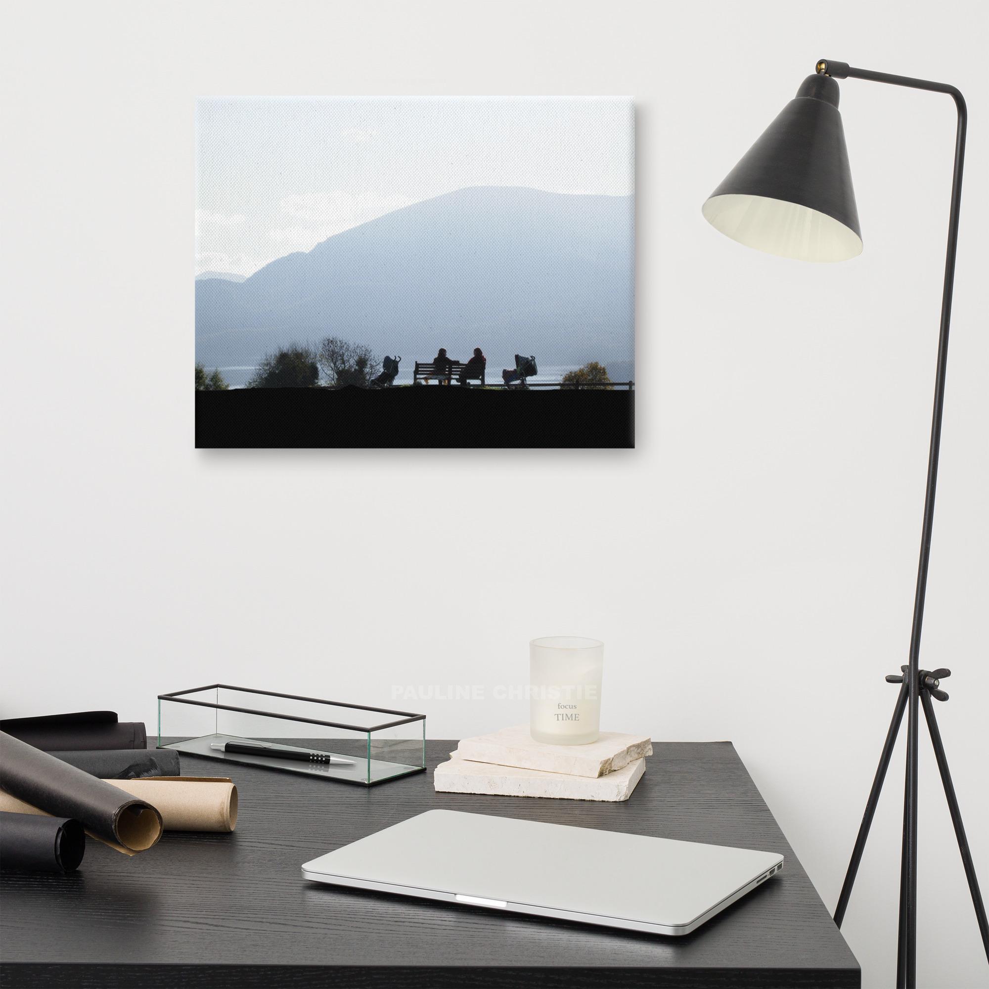 Silhouetted women chatting by Killarney Lakes with mountains in the background.