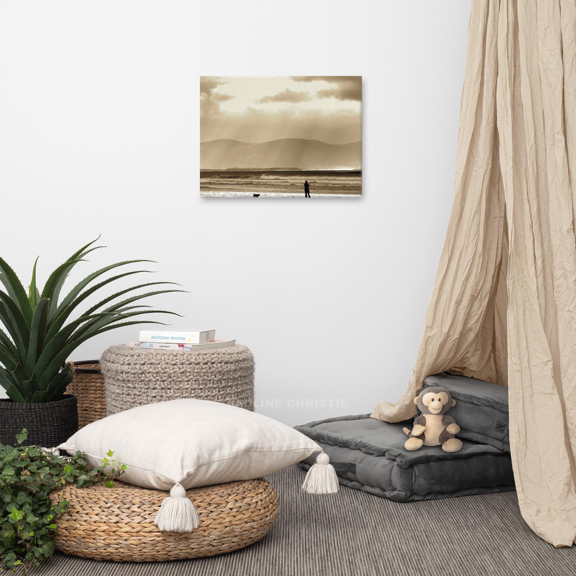 Mesmerising image of person walking dog on Inch Strand beach on a wintry day.