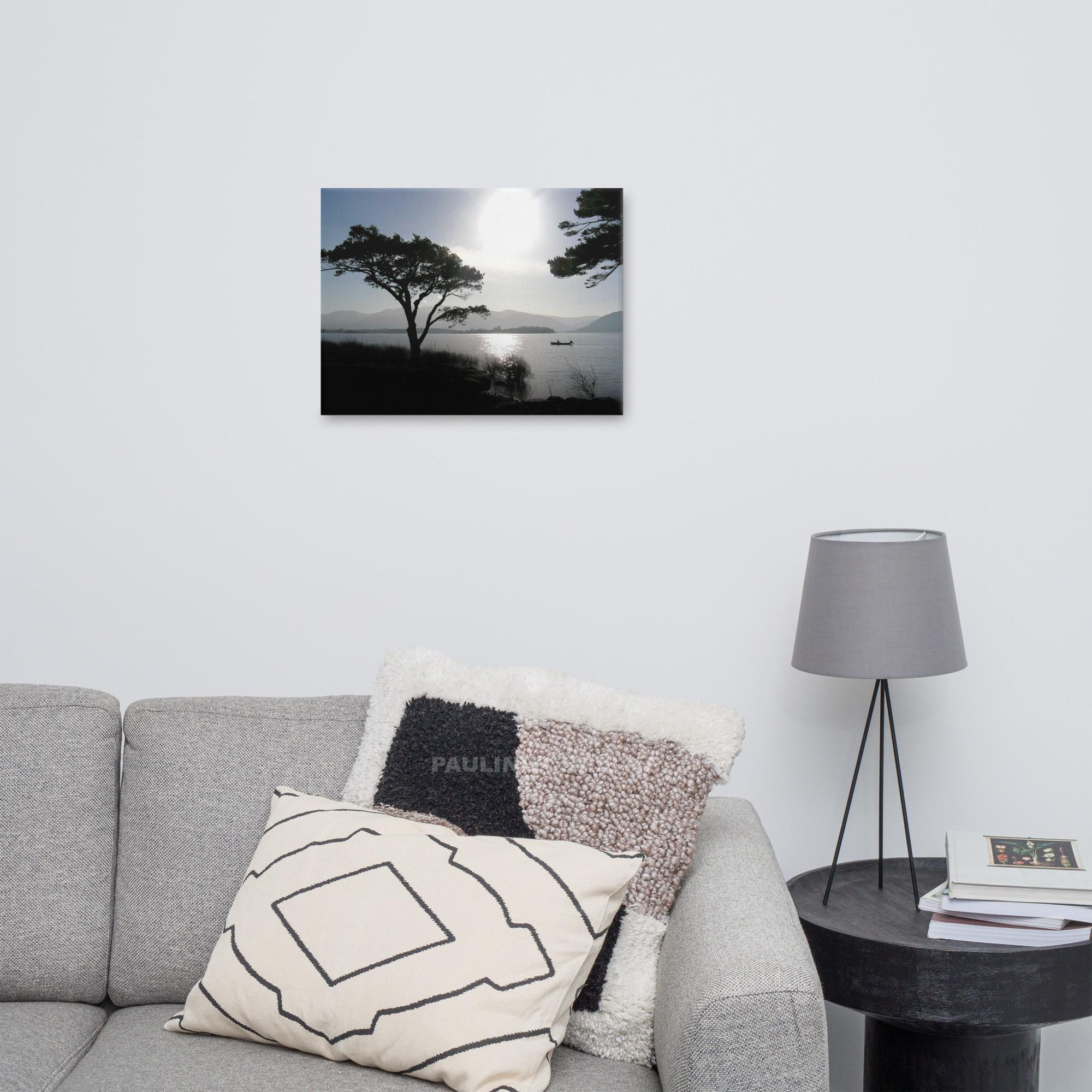 Silhouette of a fisherman out on the lakes of Killarney at sunset