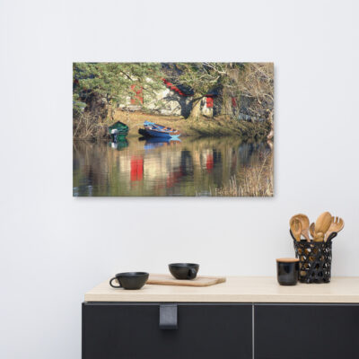 Boats on the lake at Ross Castle in Killarney reflecting in the water.